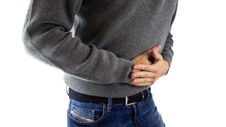 person clutching stomach in pain