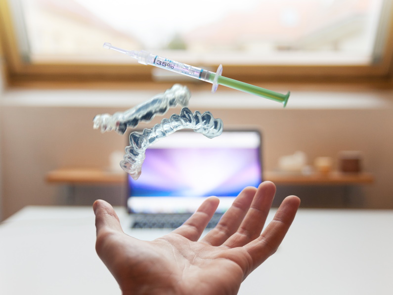 medical innovation syringe and plastic pieces floating above hand