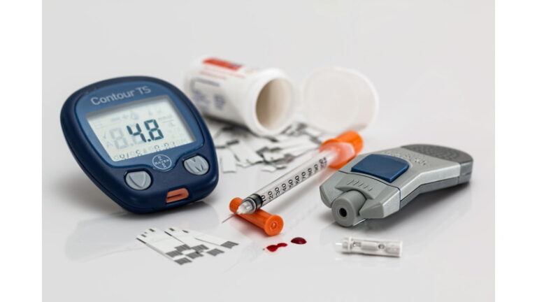 Contour TS blood glucose meter with syringe, drops of blood and bandages
