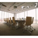 empty conference room with long table and empty chairs