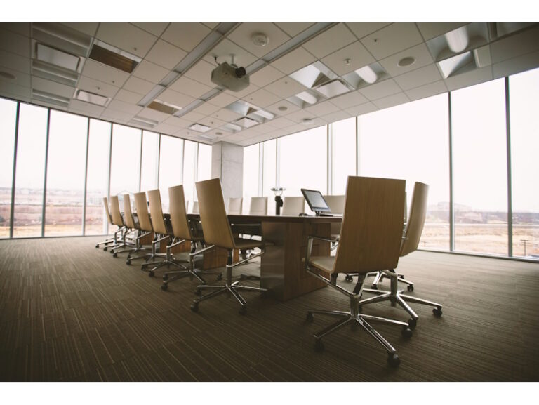 empty conference room with long table and empty chairs