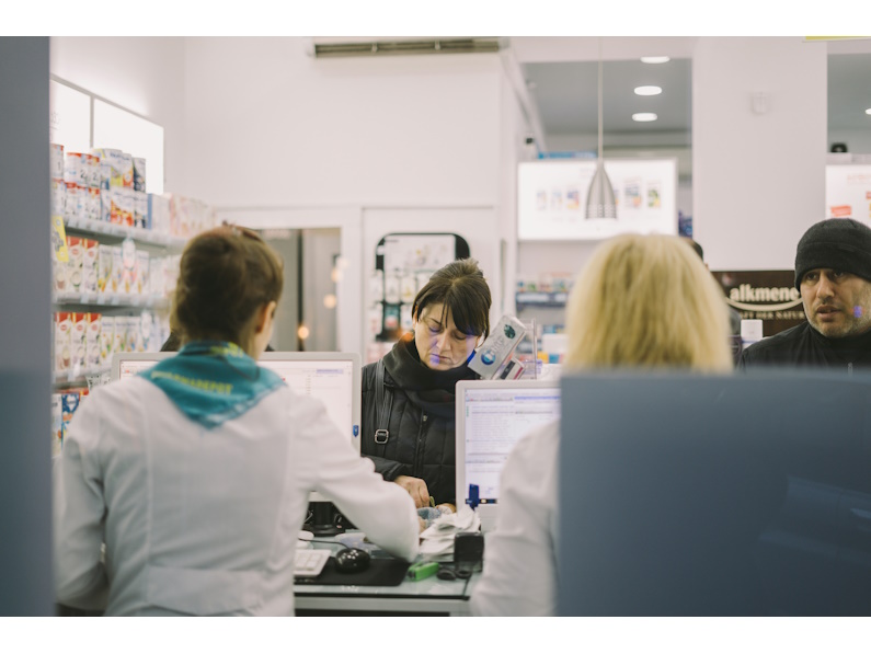 people waiting in line at a pharmacy